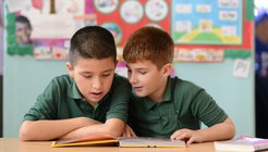Boys studying book