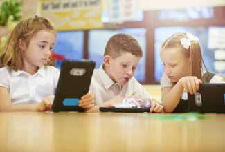 Boy and girl with technology tablet reading