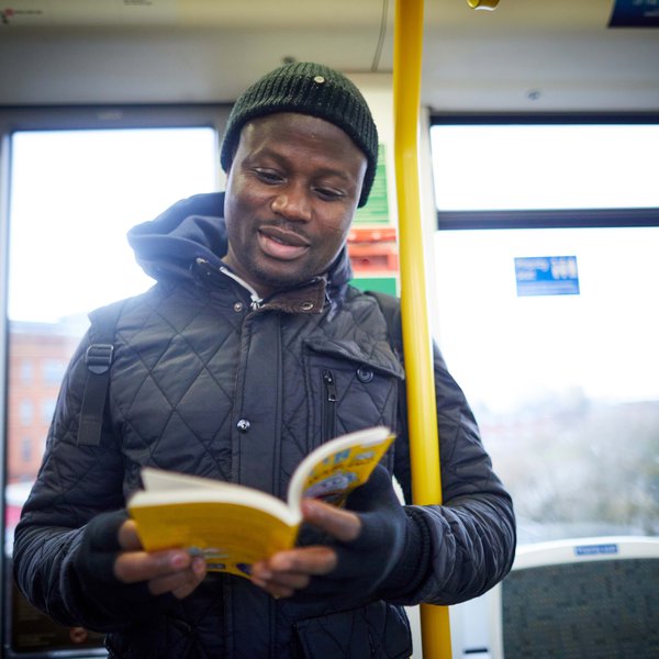 Adult reading on train