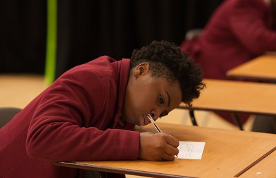 Secondary school boy writing - small
