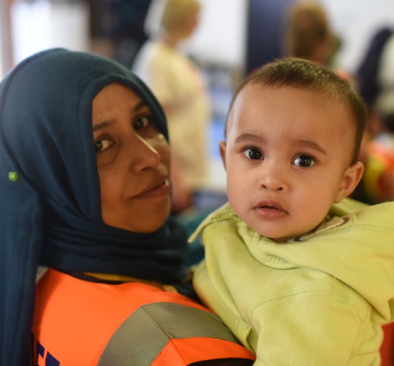 Woman in high vis carrying young boy.jpg