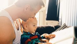 Dad sharing book with child attachment theory