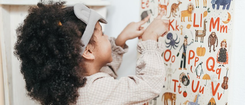 Girl looking at alphabet