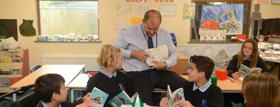 secondary school books teacher and pupil reading